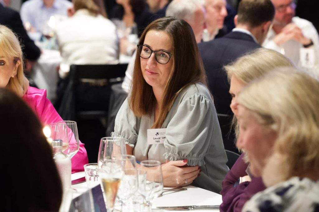 person seated at the table in the post-event dinner