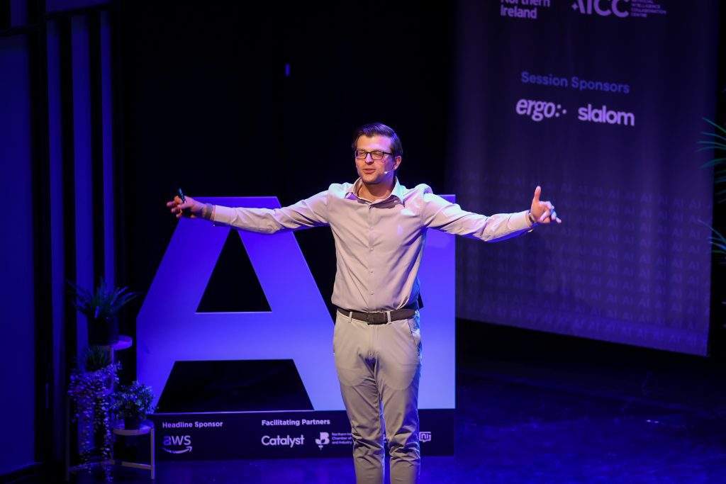 paul cheek speaking to the crowd with hands open wide, AI cutout in the back