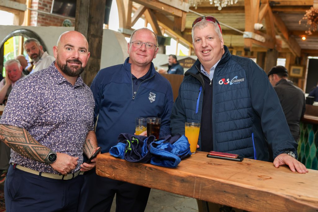 G4S's Kevin Scruby standing in the Barn Bar with two other people post-golf.