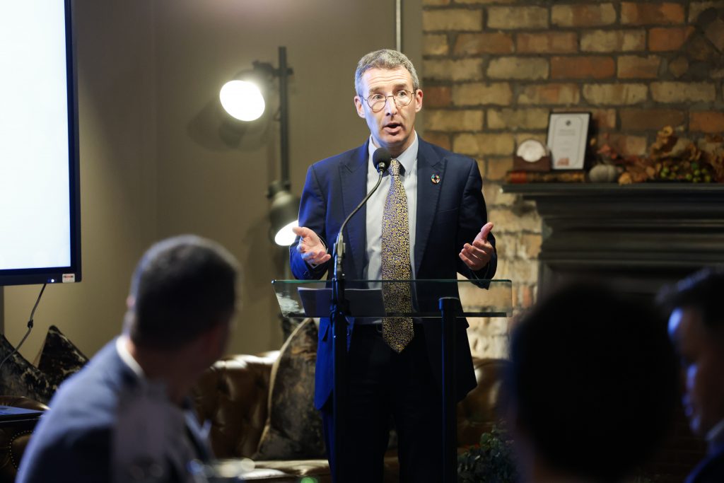 Close up of Andrew Muir speaking to people