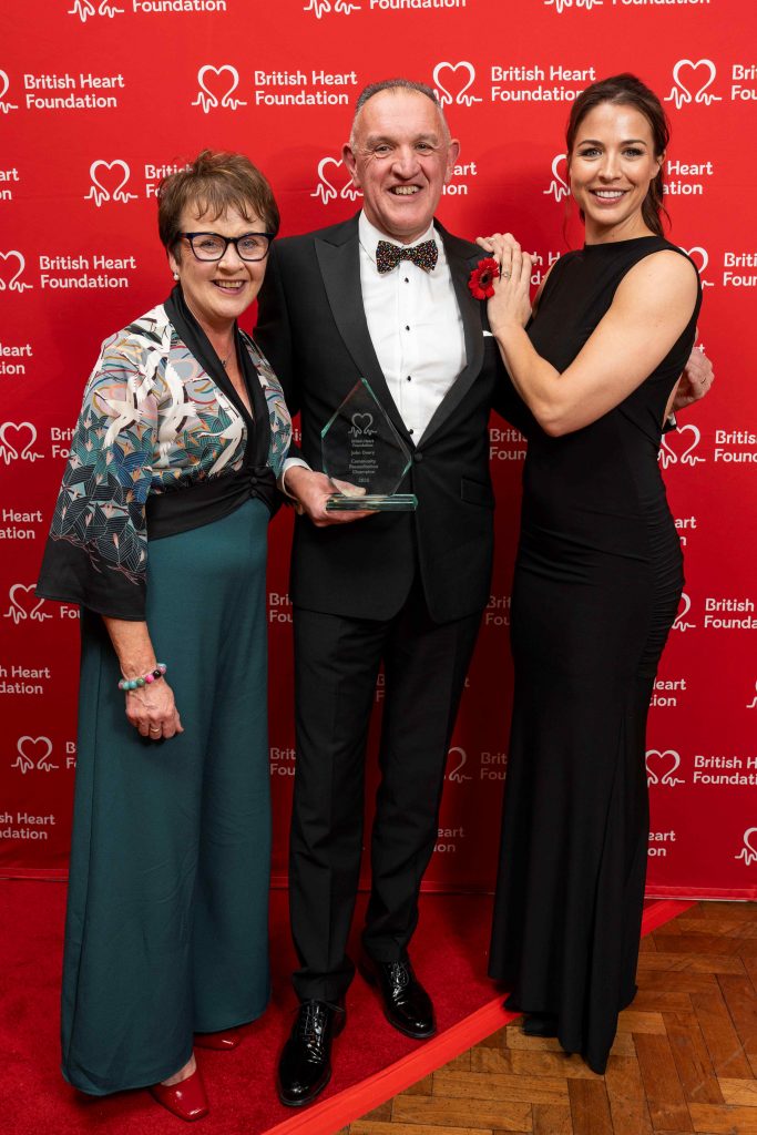 John Deery, a cardiac arrest survivor from Eglinton, has won a Community Resuscitation Champion award at the BHF Heart Hero awards ceremony in London

for his outstanding contribution to improving lifesaving skills in Northern Ireland. Pictured at the event with John is his wife Janet and actress Gemma Atkinson, who presented him with the award.

 