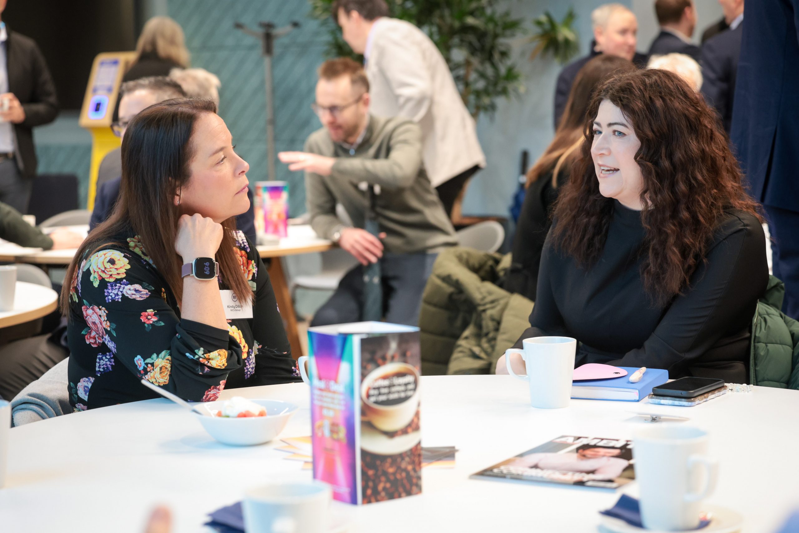 Attendees speak with each other during a networking break.
