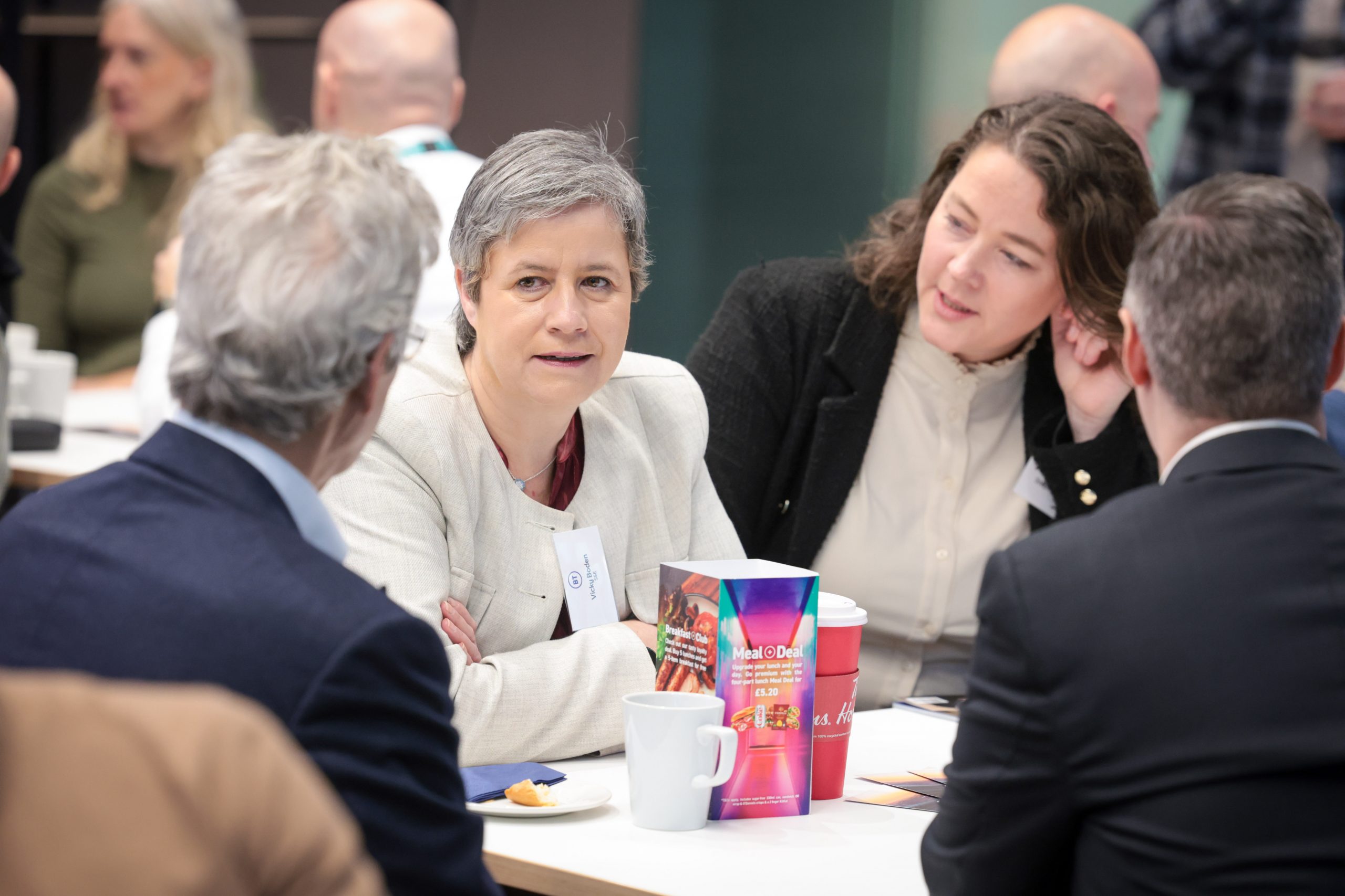 Attendees speak with each other during a networking break.